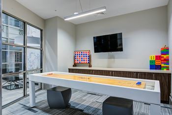 Game room with shuffleboard, XBox, and old school arcade games